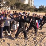 Tai Chi Class Sufers On the Beach